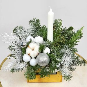 A winter-themed Christmas centerpiece arranged in a small, square