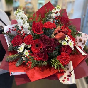 Christmas arrangement with red amaryllis and roses